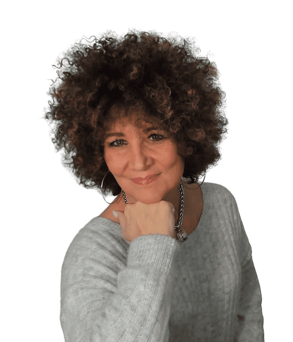 Smiling woman with curly hair resting her chin on her hand.